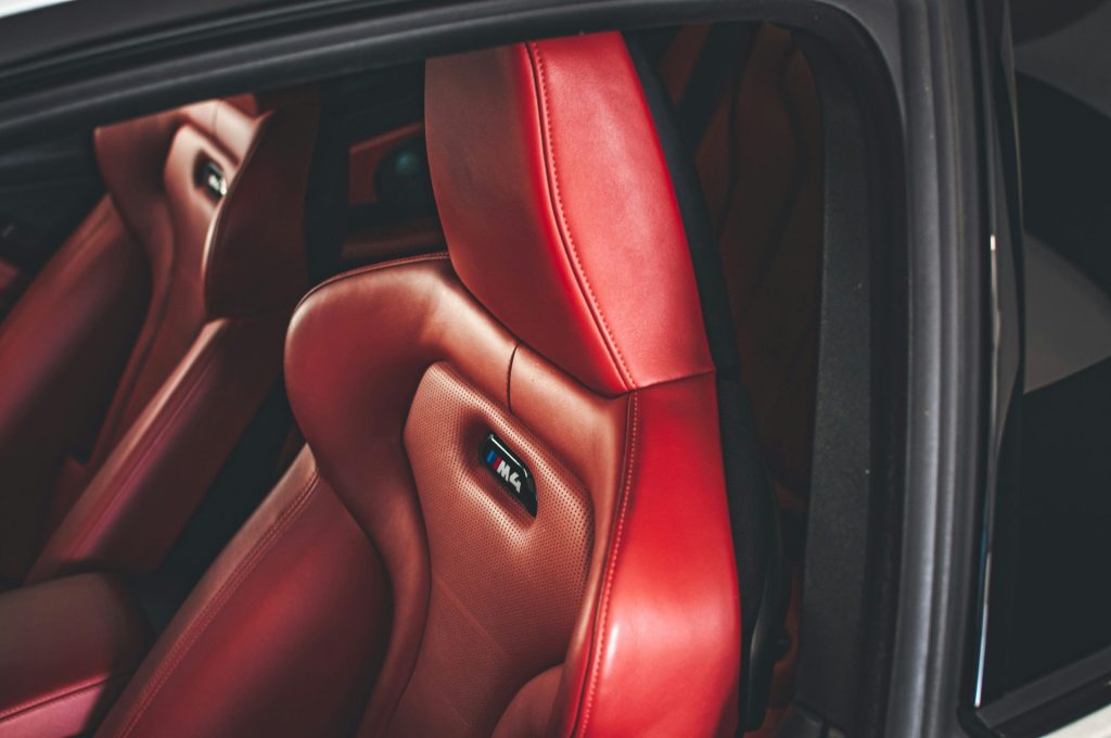 the interior of a car with red leather seats